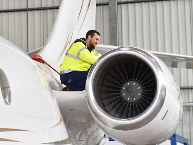 Certified aircraft maintenance technician performs rigorous safety inspection on private jet before charter flight takeoff at Fly Advanced FBO