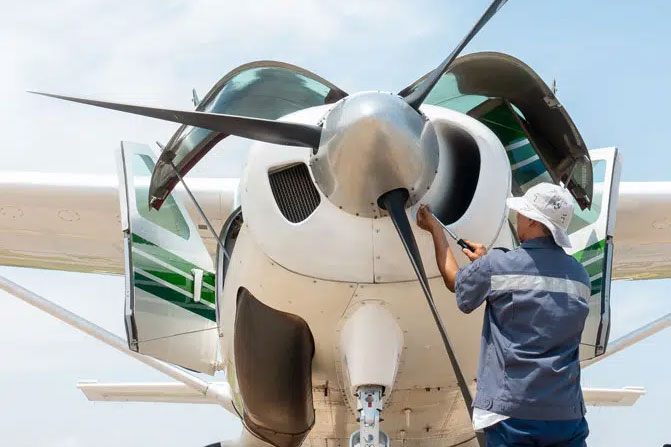 Aircraft maintenance technician inspects private jet for flight safety inspection